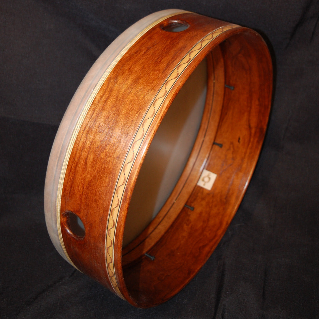 An image of an Asheville Rhythm Series Tars drum with a wooden body and a rhythmic-wave patterned inlay.