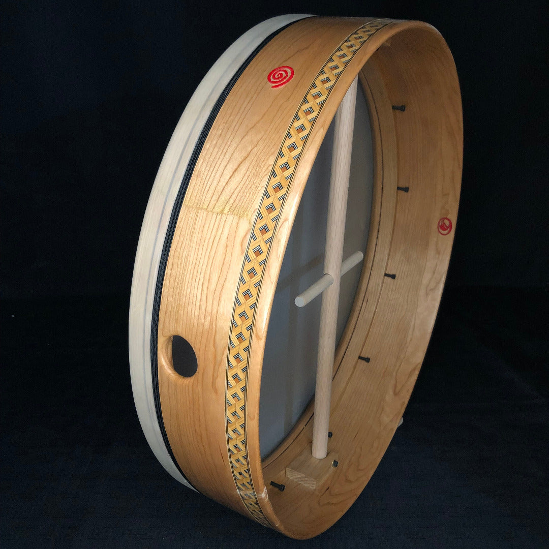 A Velez Series 20-inch diameter cherry wood bodhran drum with a single removable crossbar and a clear lacquer finish with black cording.