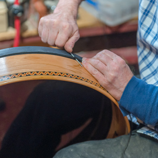 frame drum head cording being tightened