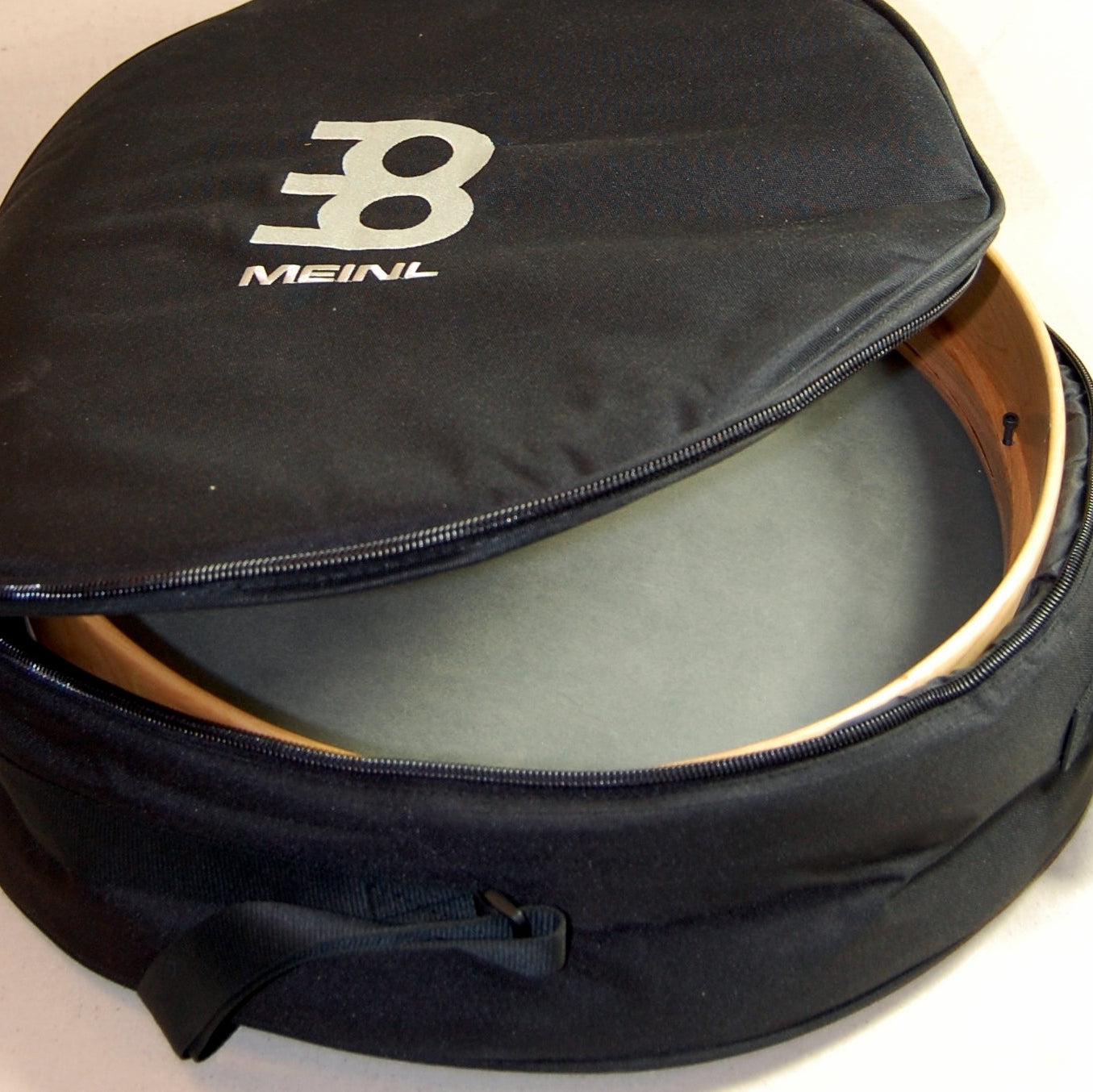 A Meinl branded padded nylon drum bag with a zippered pocket, padded handle, and a shoulder strap.
